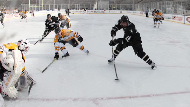 a group of hockey players on the ice playing