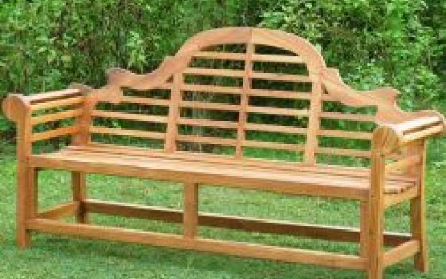 a wooden bench sitting in the grass