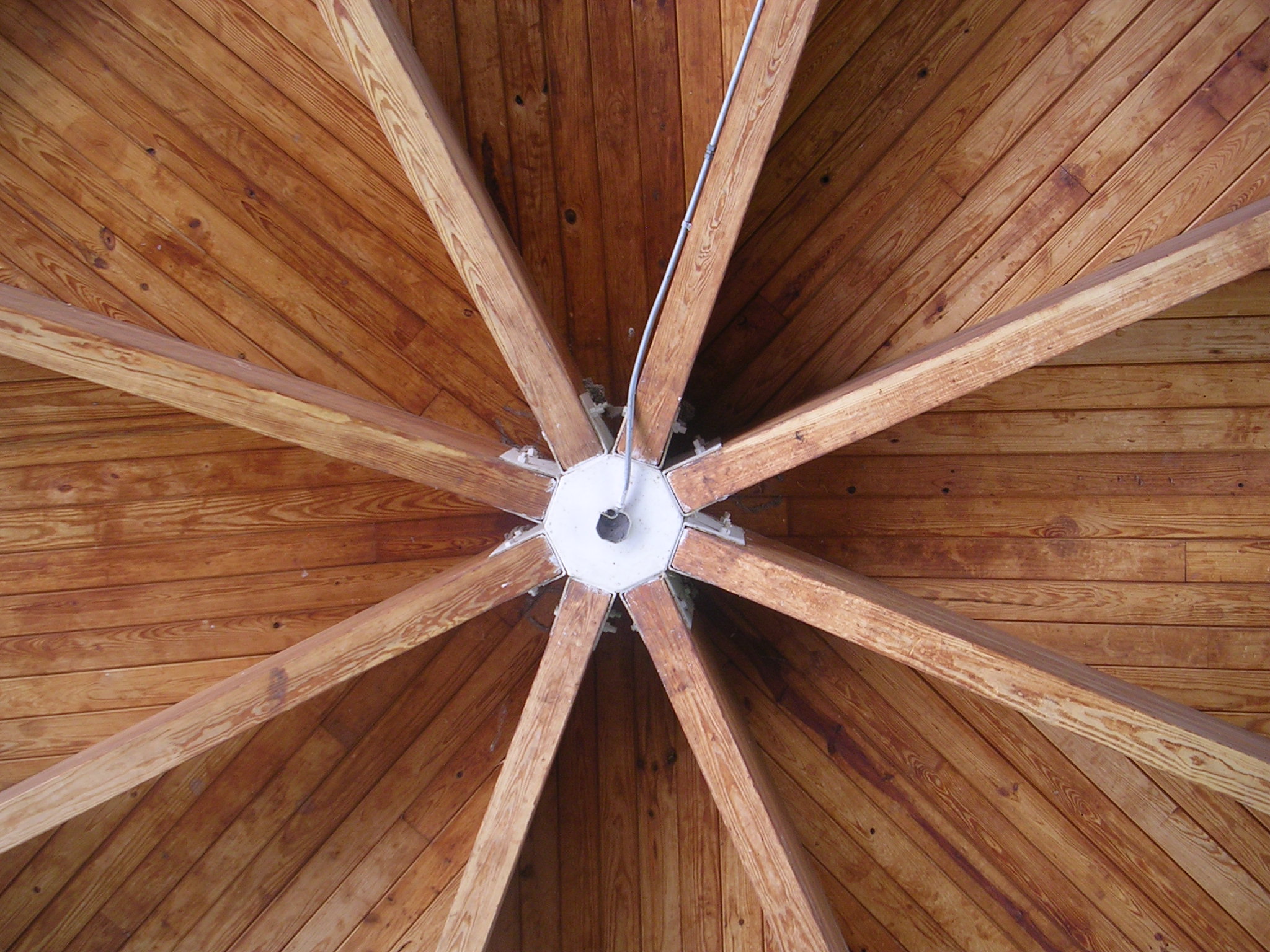 a wooden umbrella has a white line down the middle