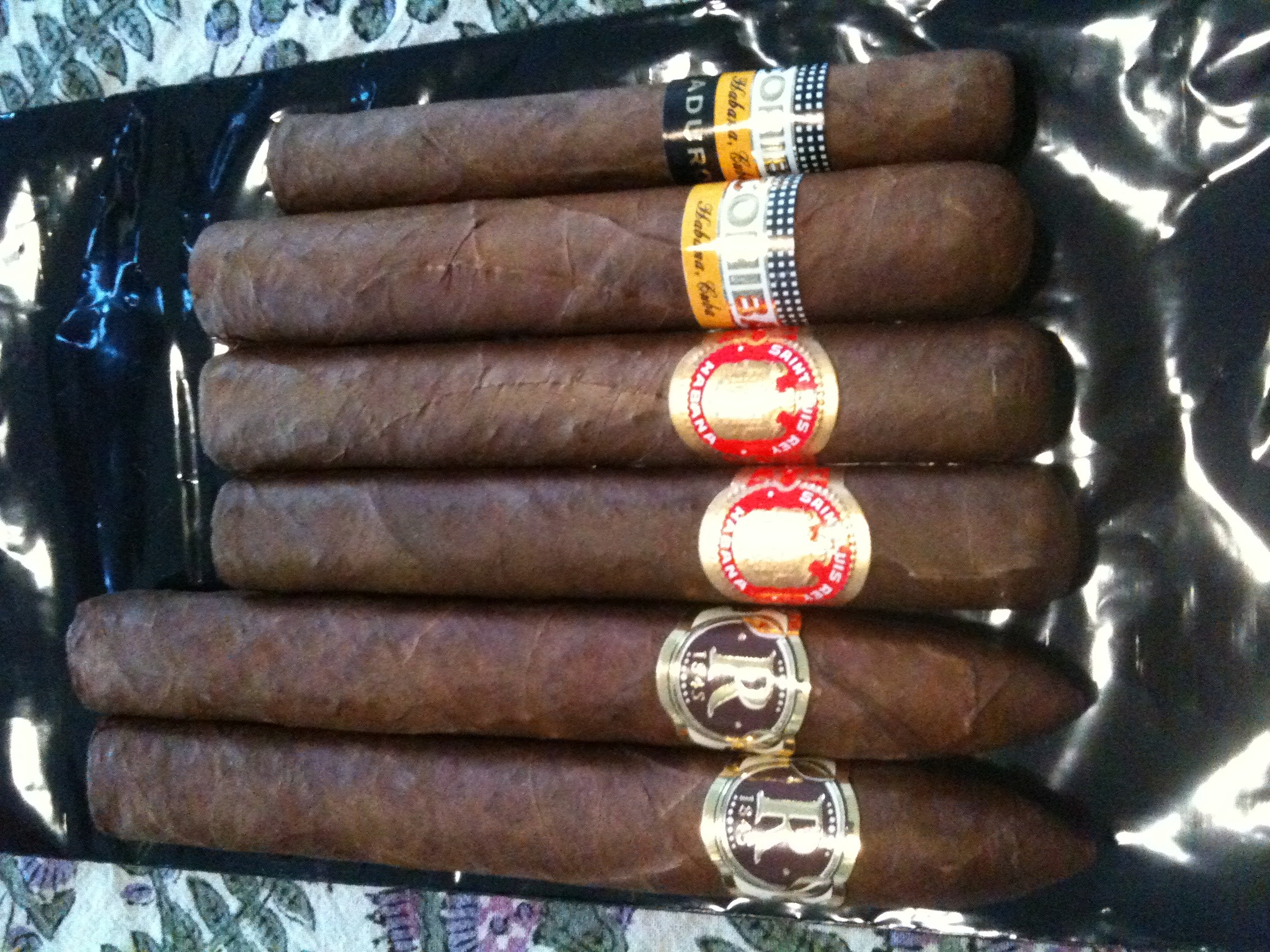 six cigars are shown in the case