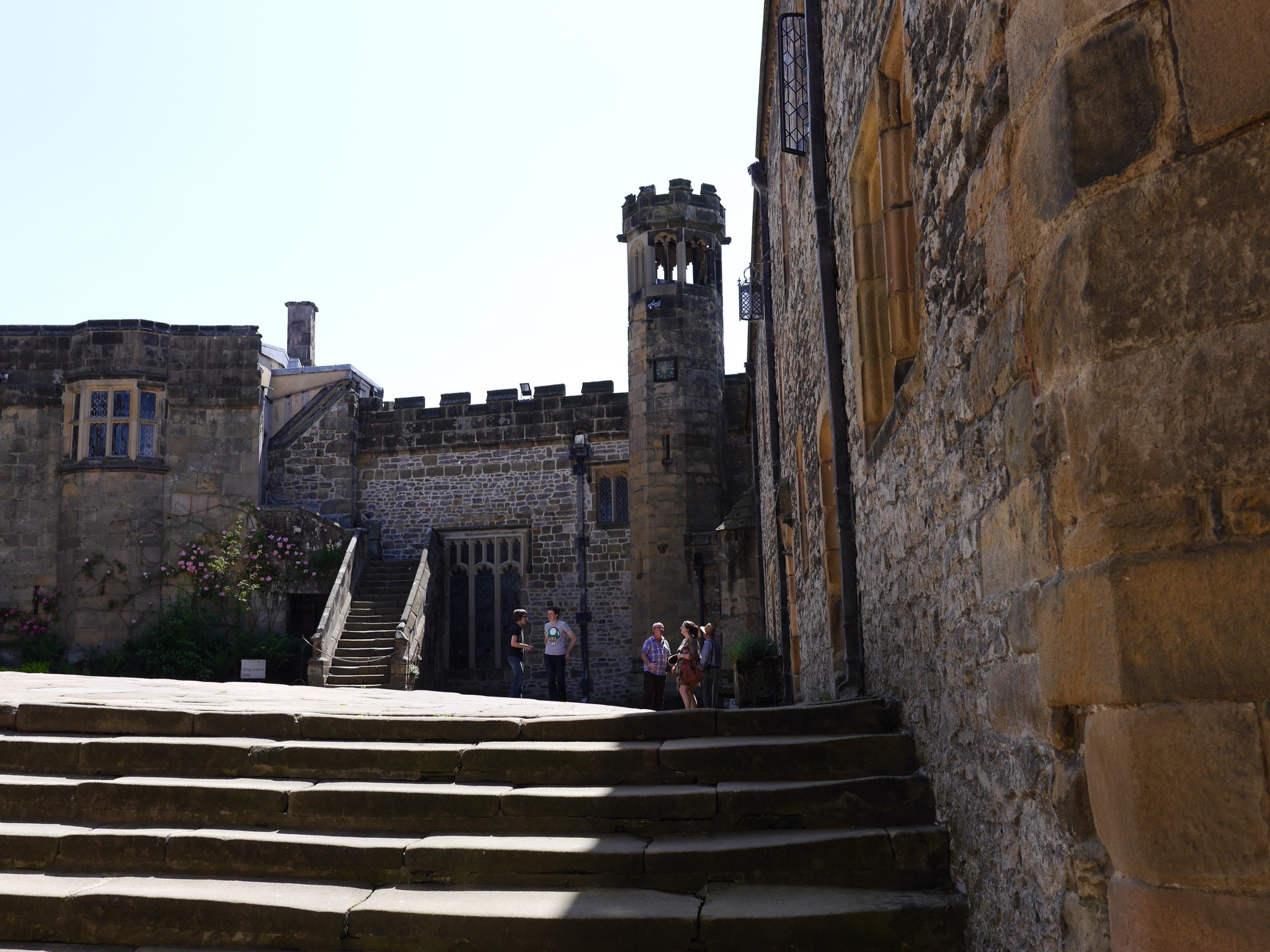 some people are standing on stairs and a clock tower