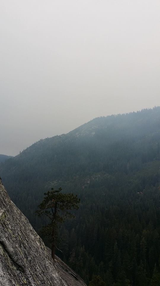 an person standing on top of a cliff on a mountain