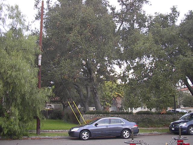 two cars sitting in the lot of a residential neighborhood