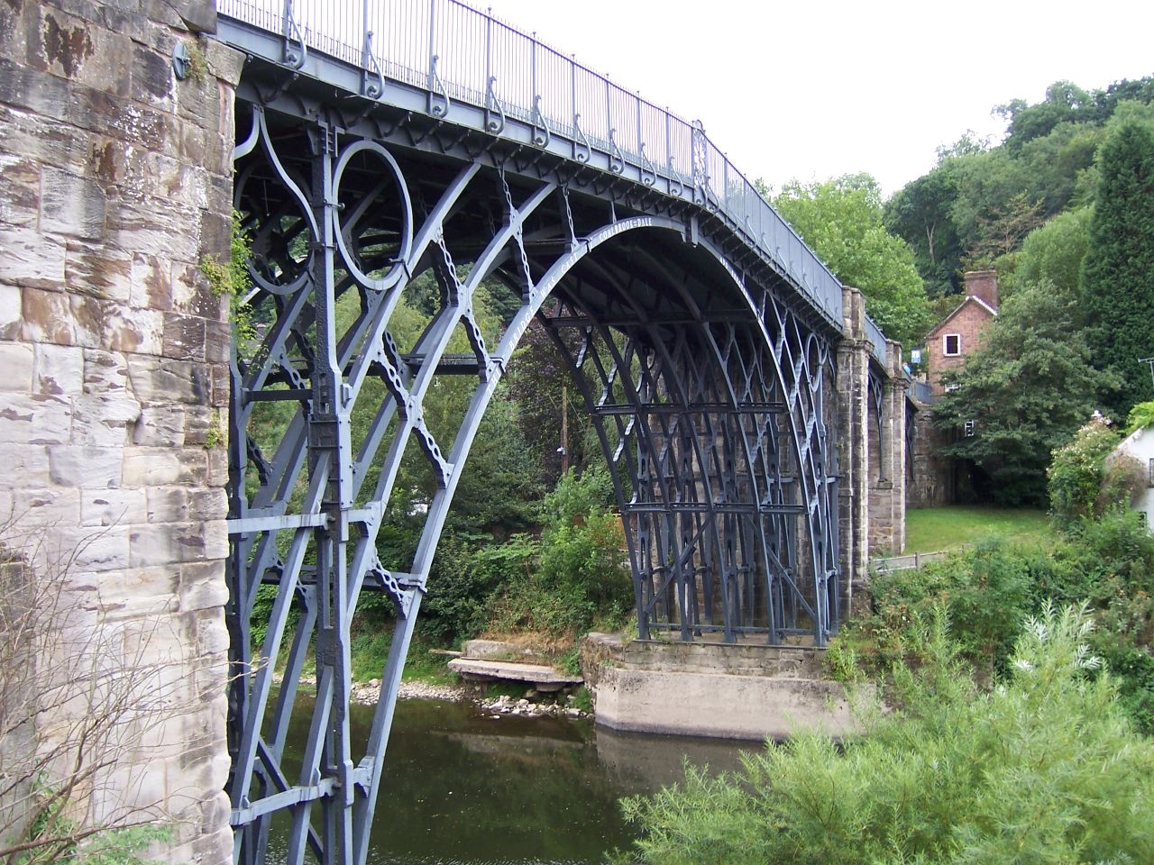 bridge with blue metal framing and railing in urban area