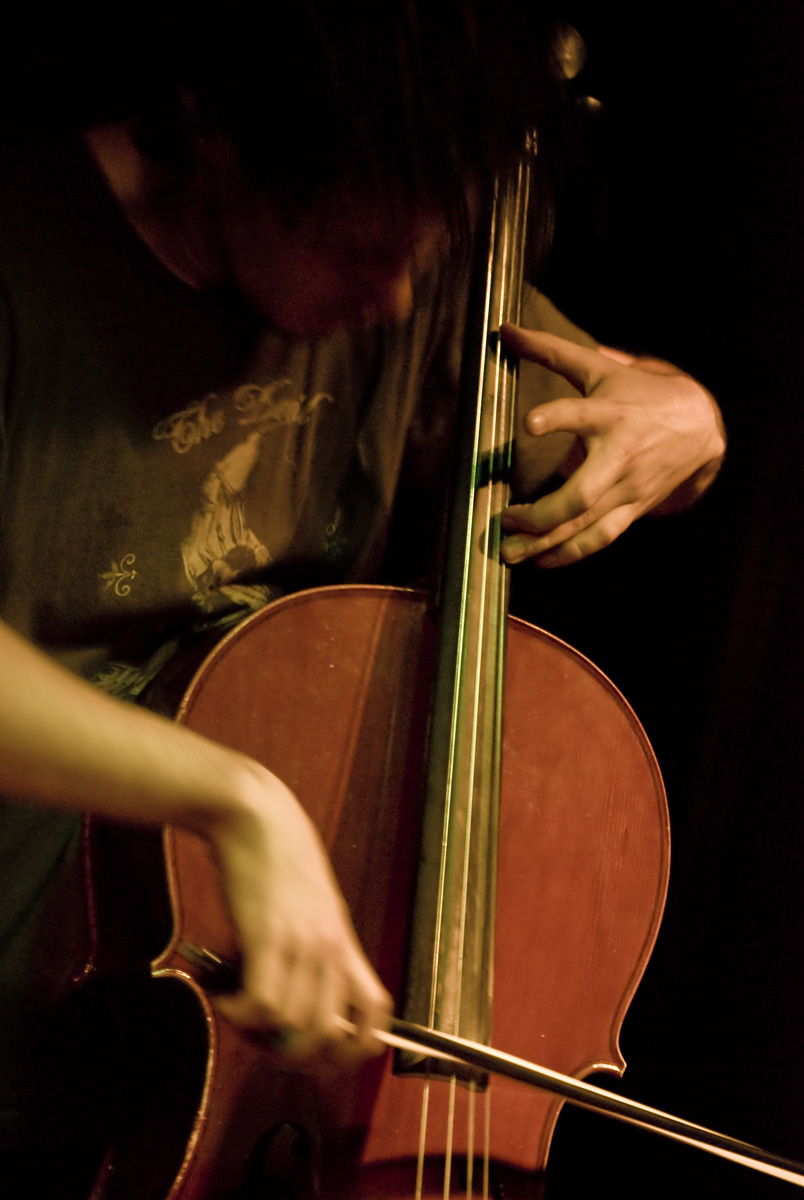 a person that is playing a cello on stage