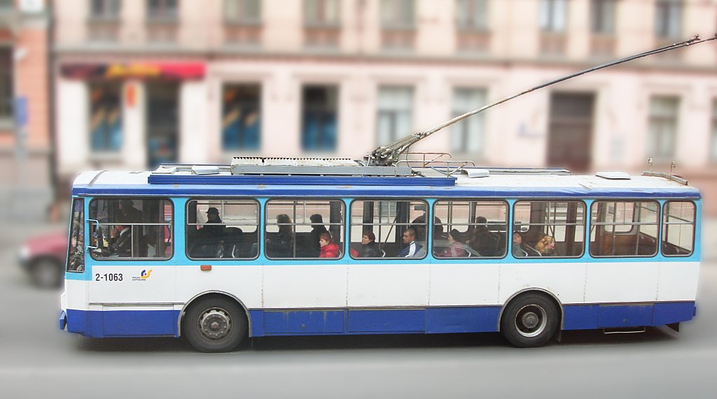 an old blue and white bus in a street