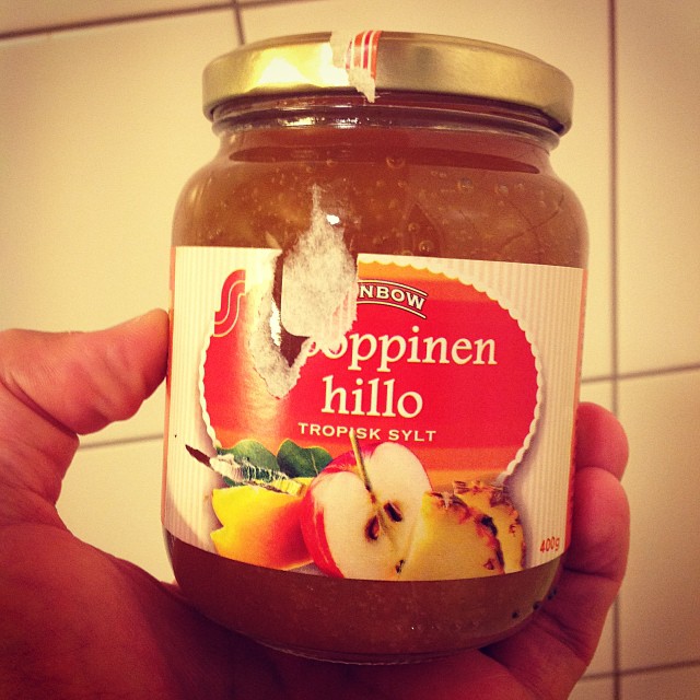 there is a jar of apple halico sauce in the person's hand