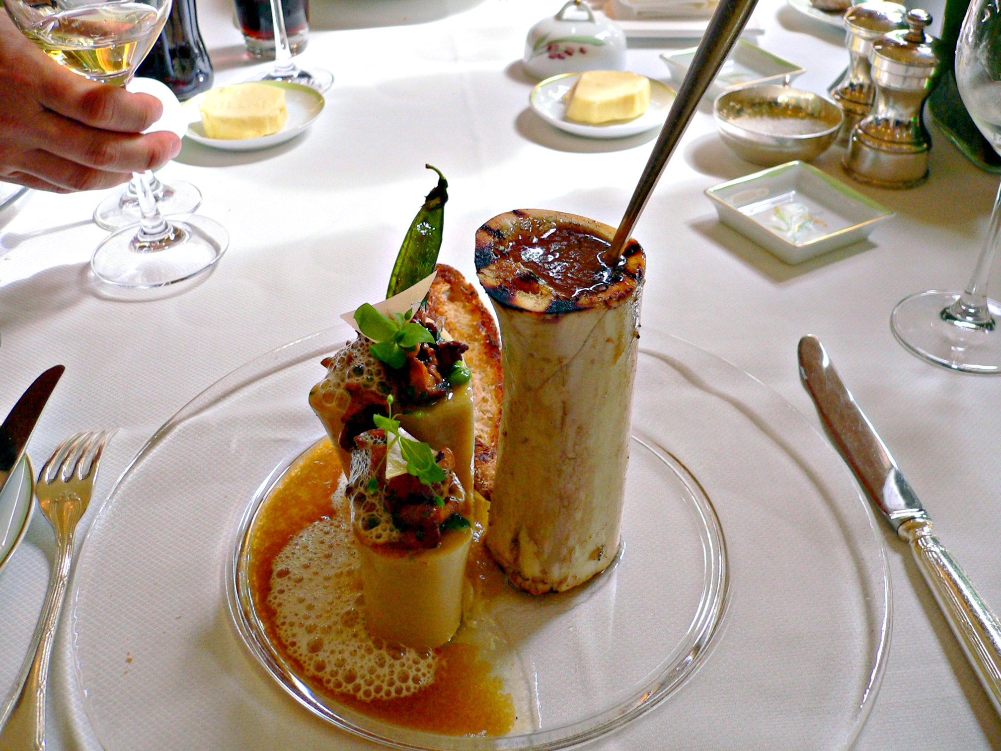 a dessert and condiments at a fancy dinner table