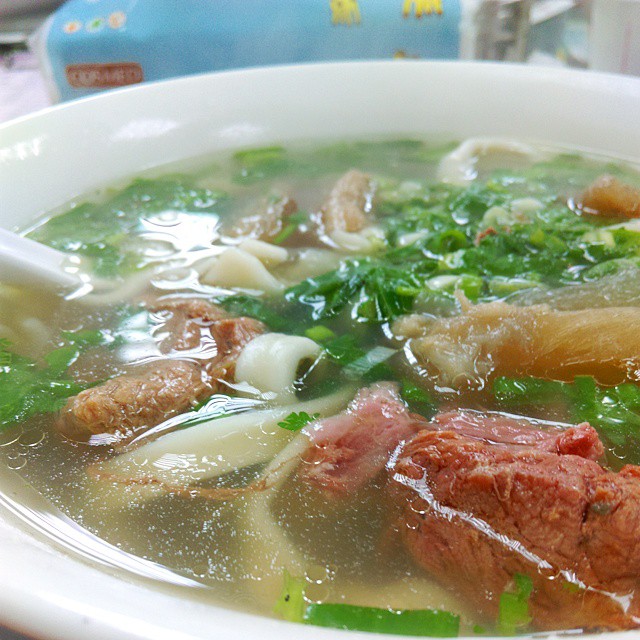 a bowl filled with noodles and meat soup
