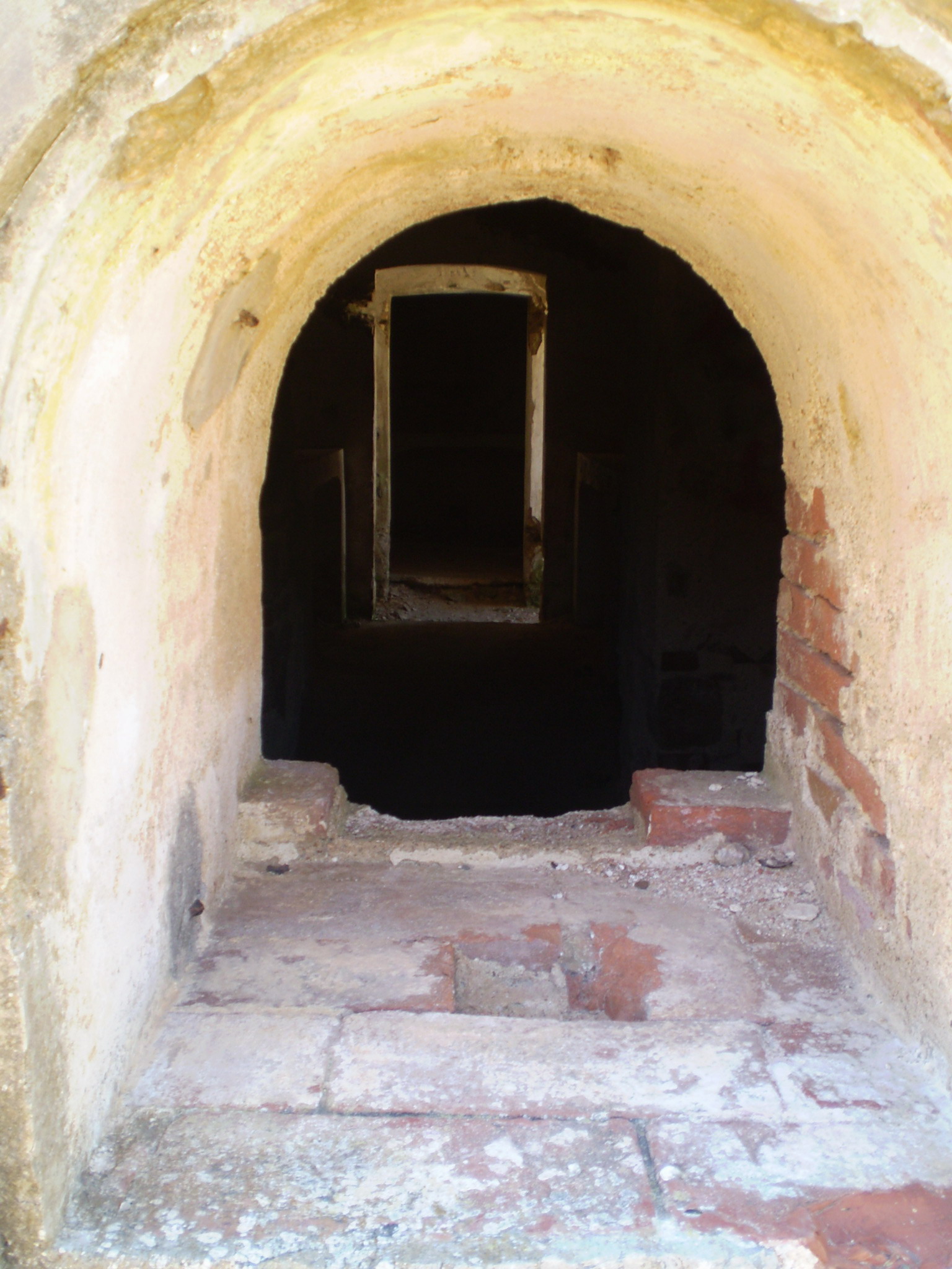 a tunnel entrance to a concrete cellar area