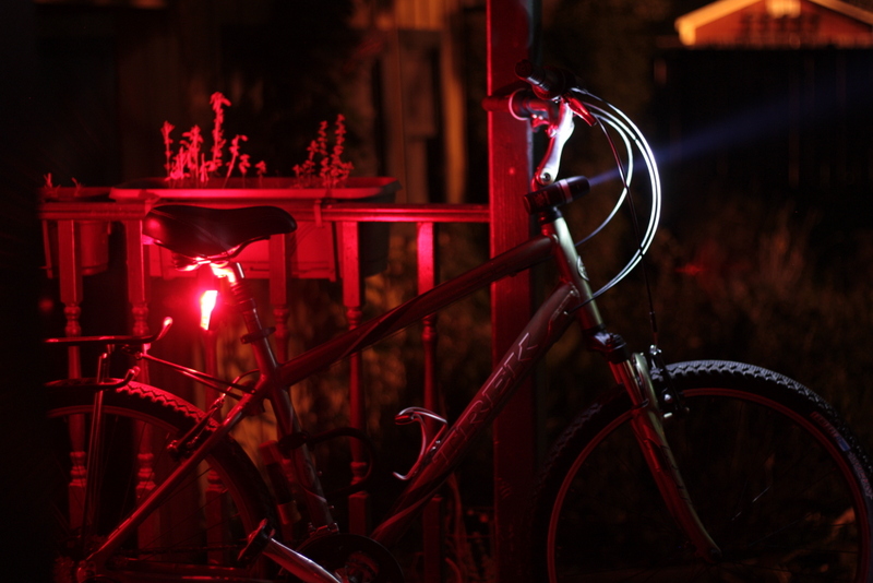 the bicycle is illuminated by a red light