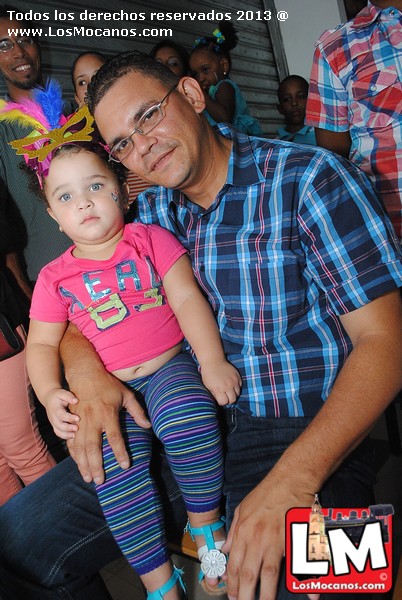 a man with a small girl wearing colorful clothes
