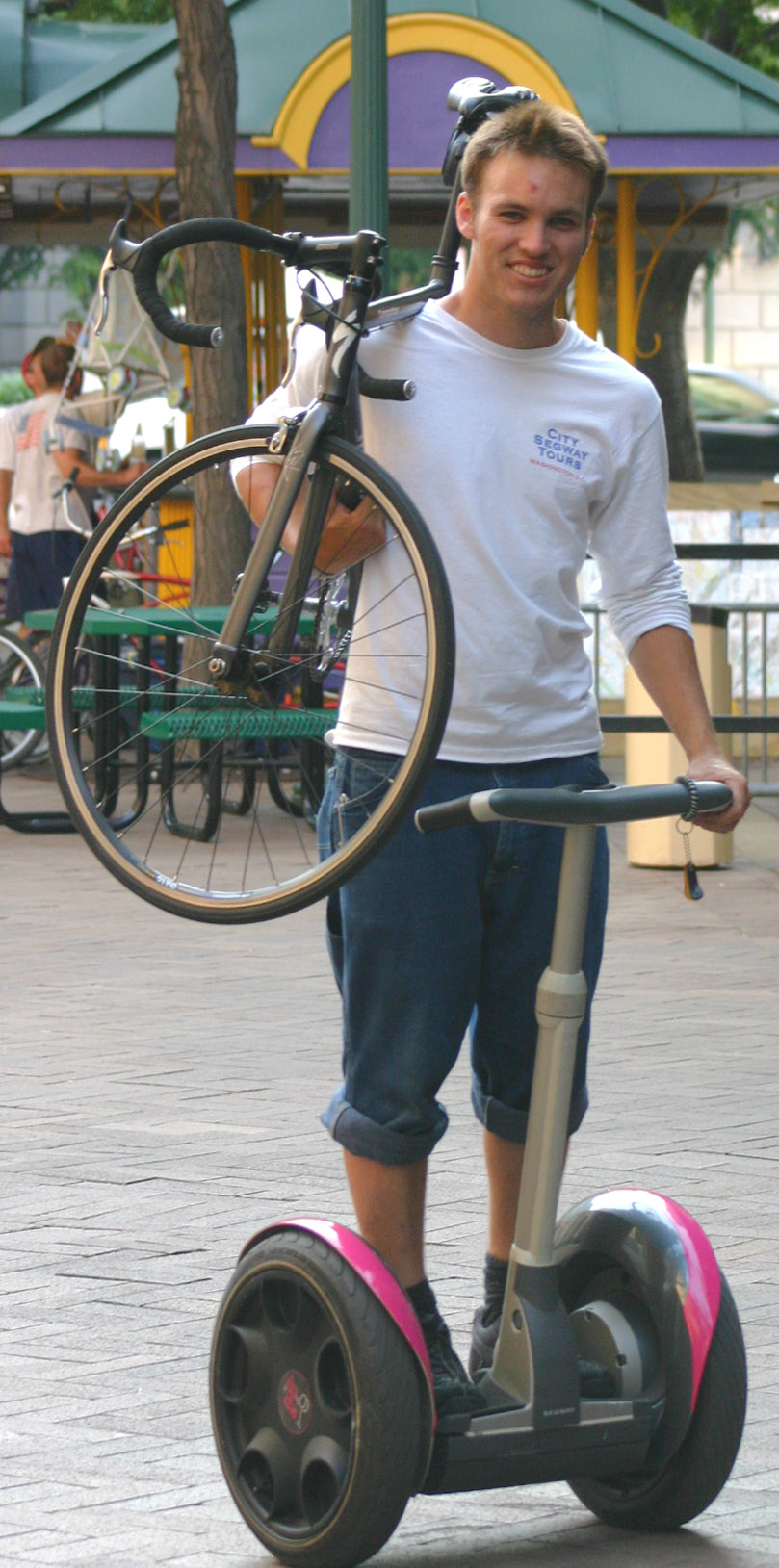 a young man is hing a pink scooter