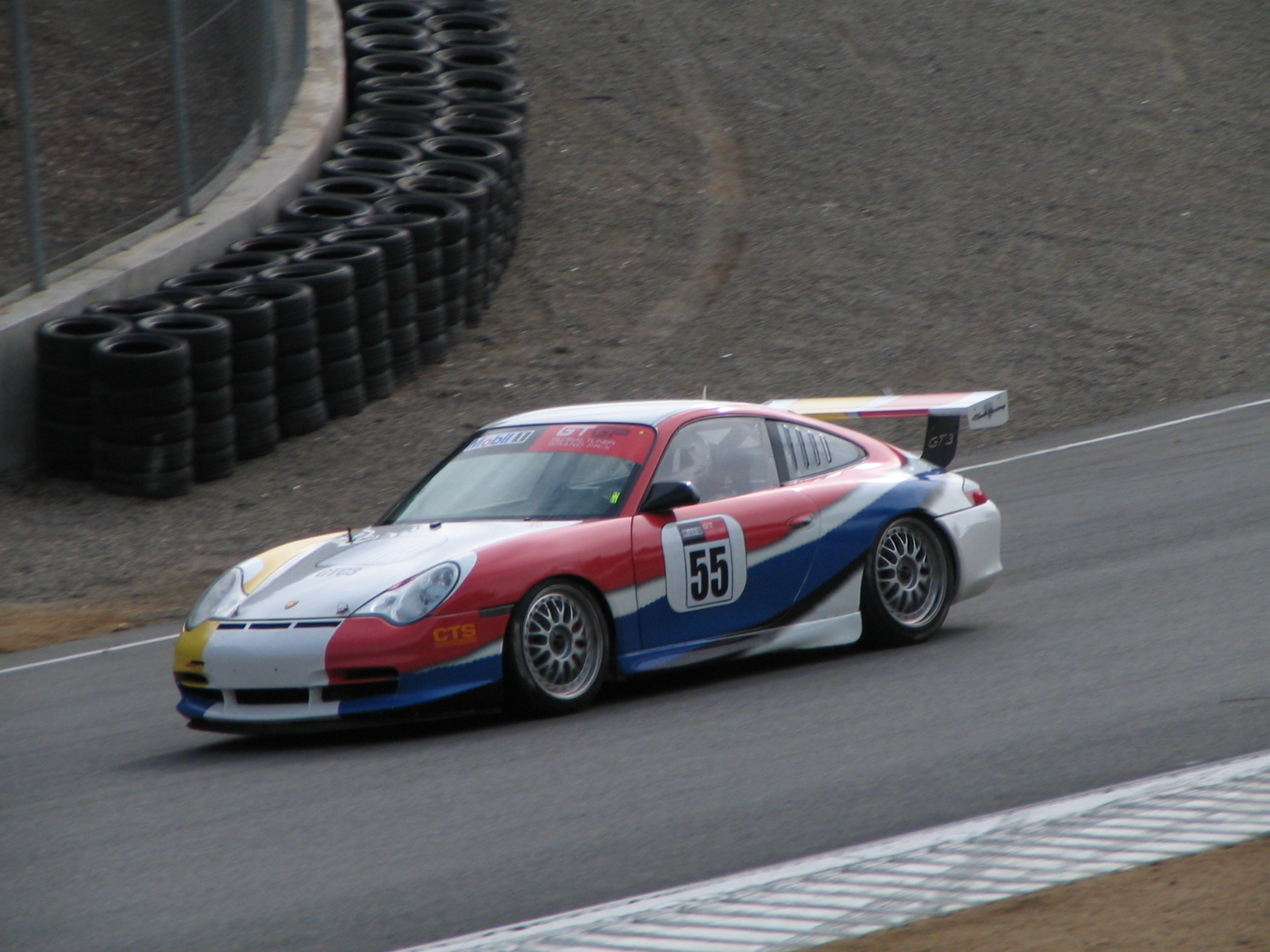 a red and white porsche race car on a track