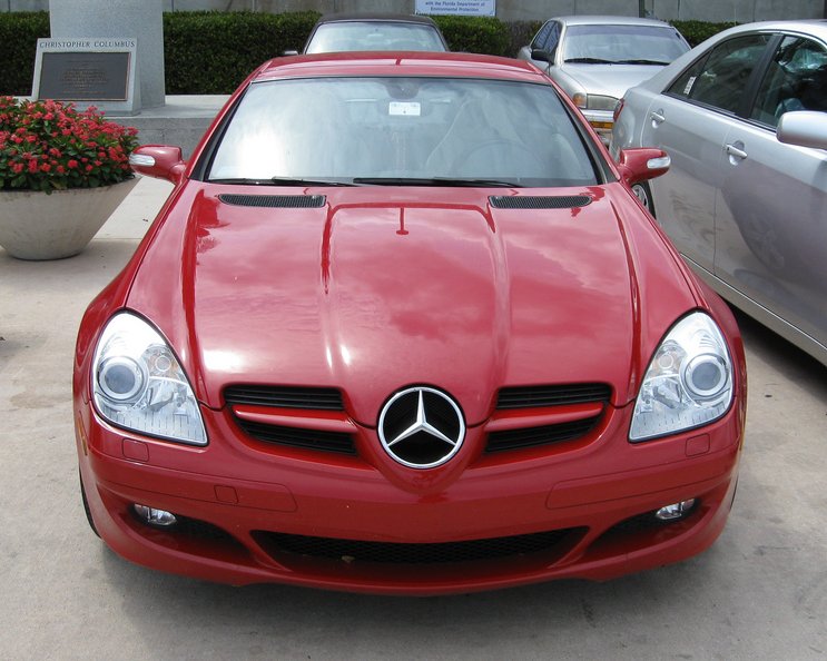 two cars parked next to each other on the ground