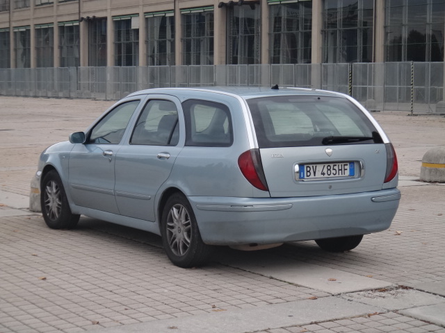 a light blue car that is sitting on the ground