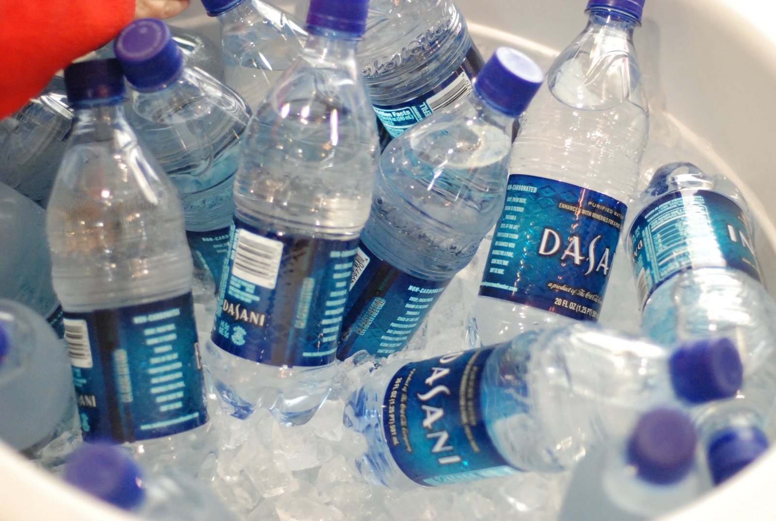 several bottled water bottles are filled with ice