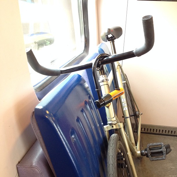 a bike resting against a wall on a train