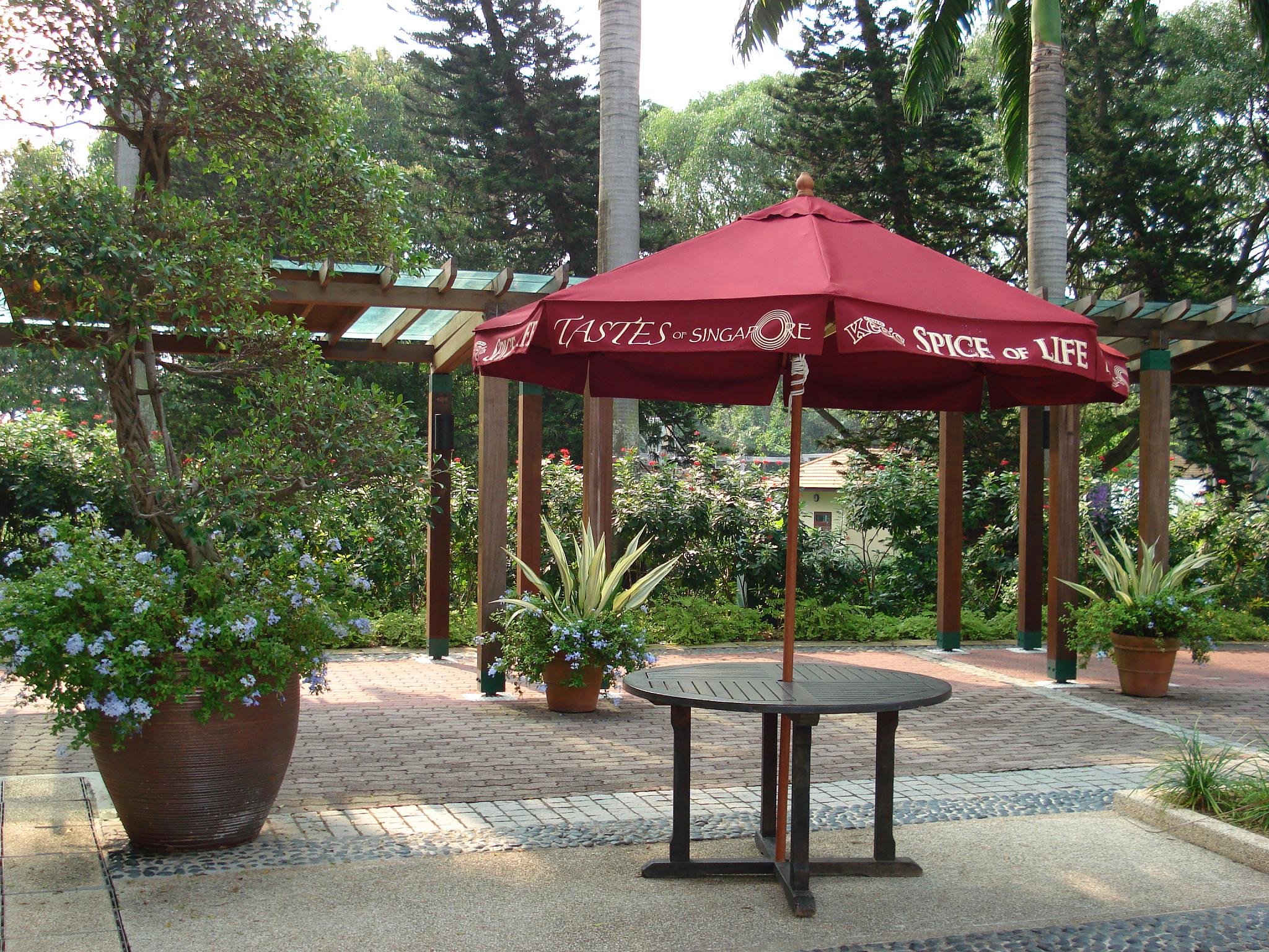 a small patio with table and umbrella for shade