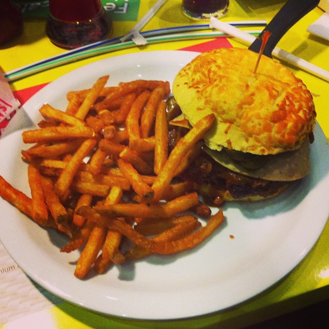 the plate has french fries on it and an egg sandwich