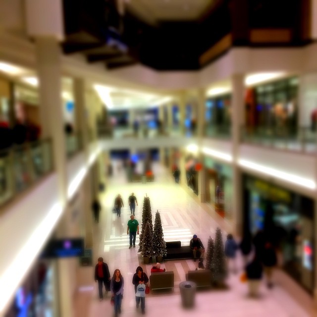 a blurry s of people walking in a mall