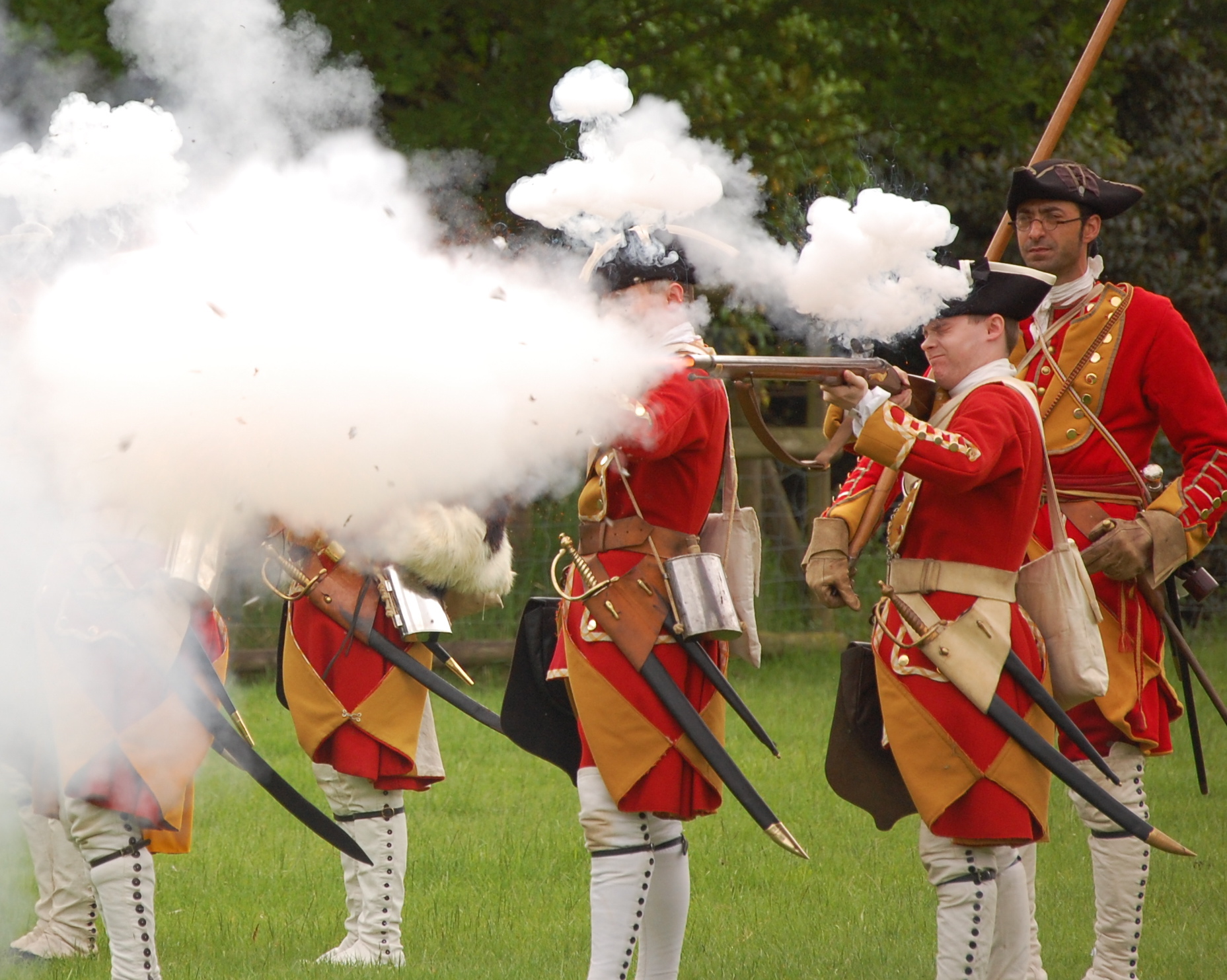 a group of men in uniforms holding swords and smoking