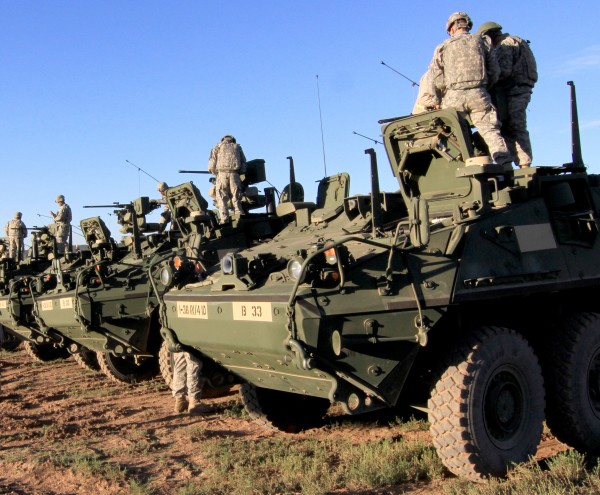 a bunch of military vehicles lined up in a field