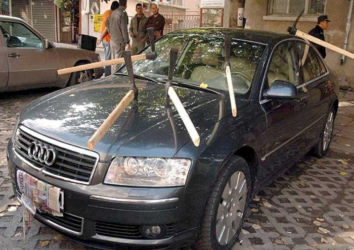 a car with a bat stuck to the windshield