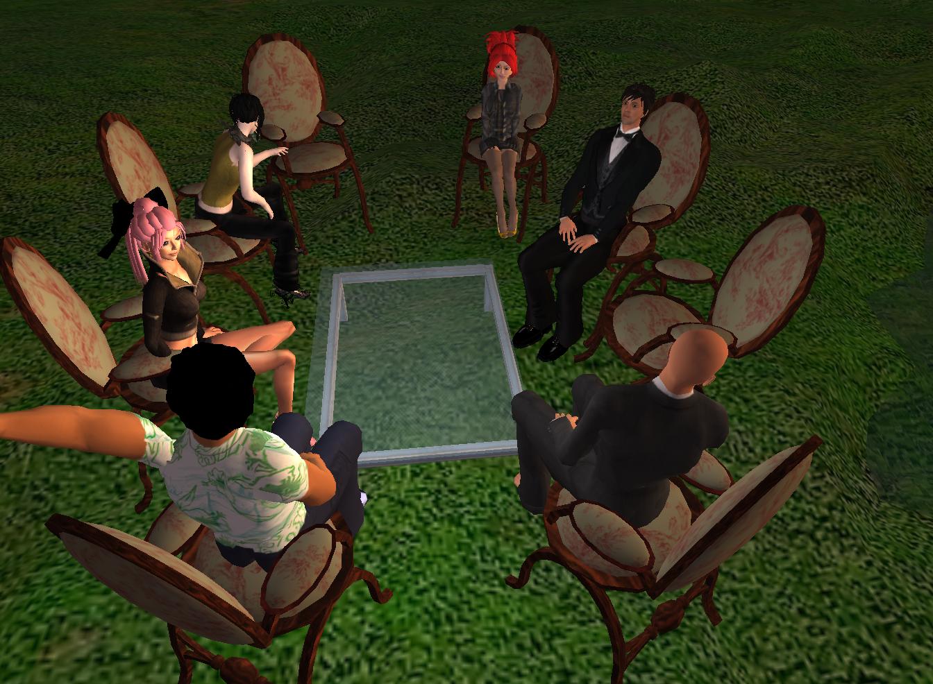 a group of people sitting in chairs looking at soing