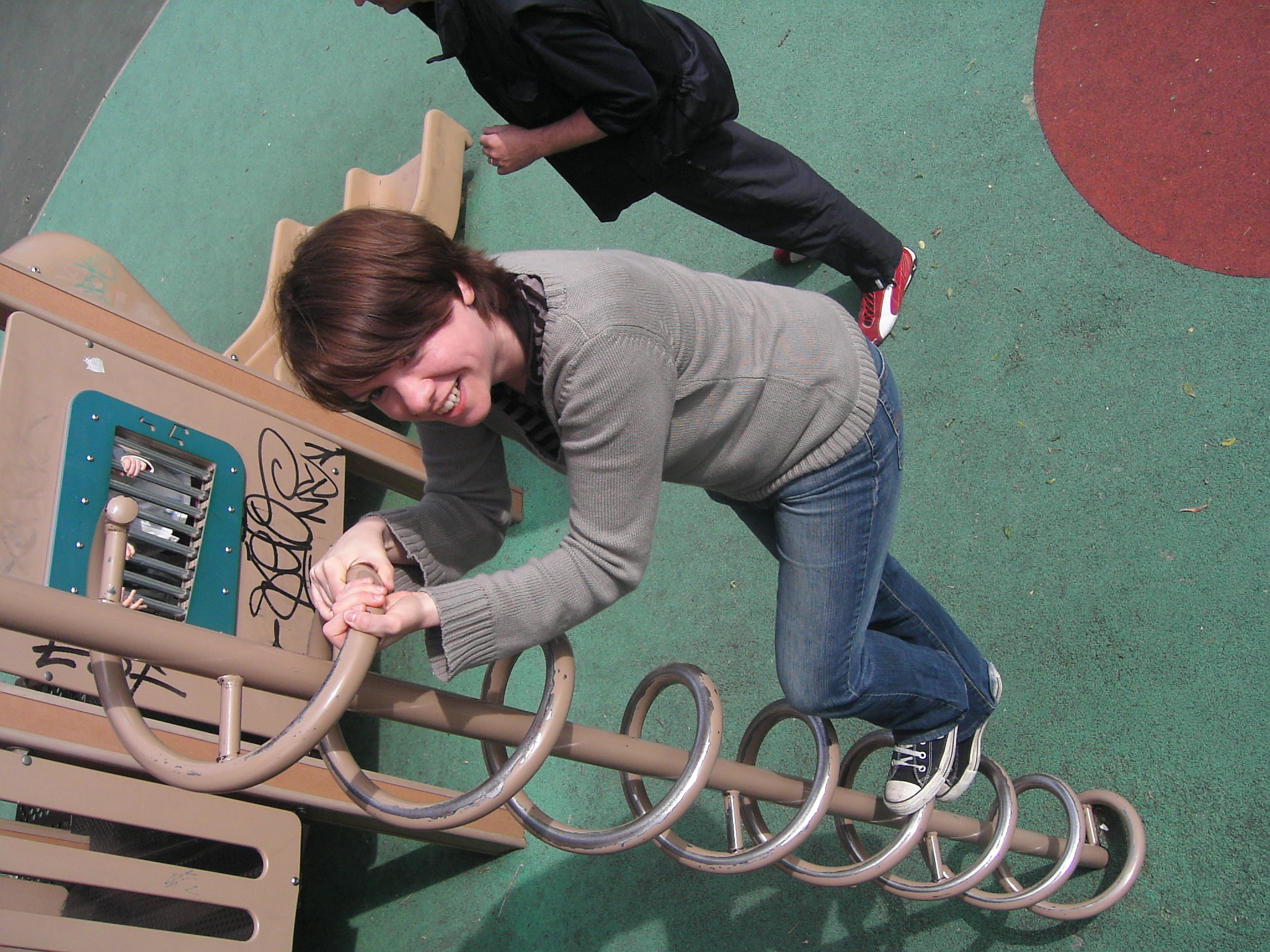 a girl climbing on a playground play structure
