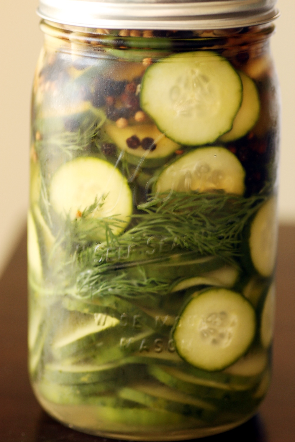 a jar filled with different vegetables on a table