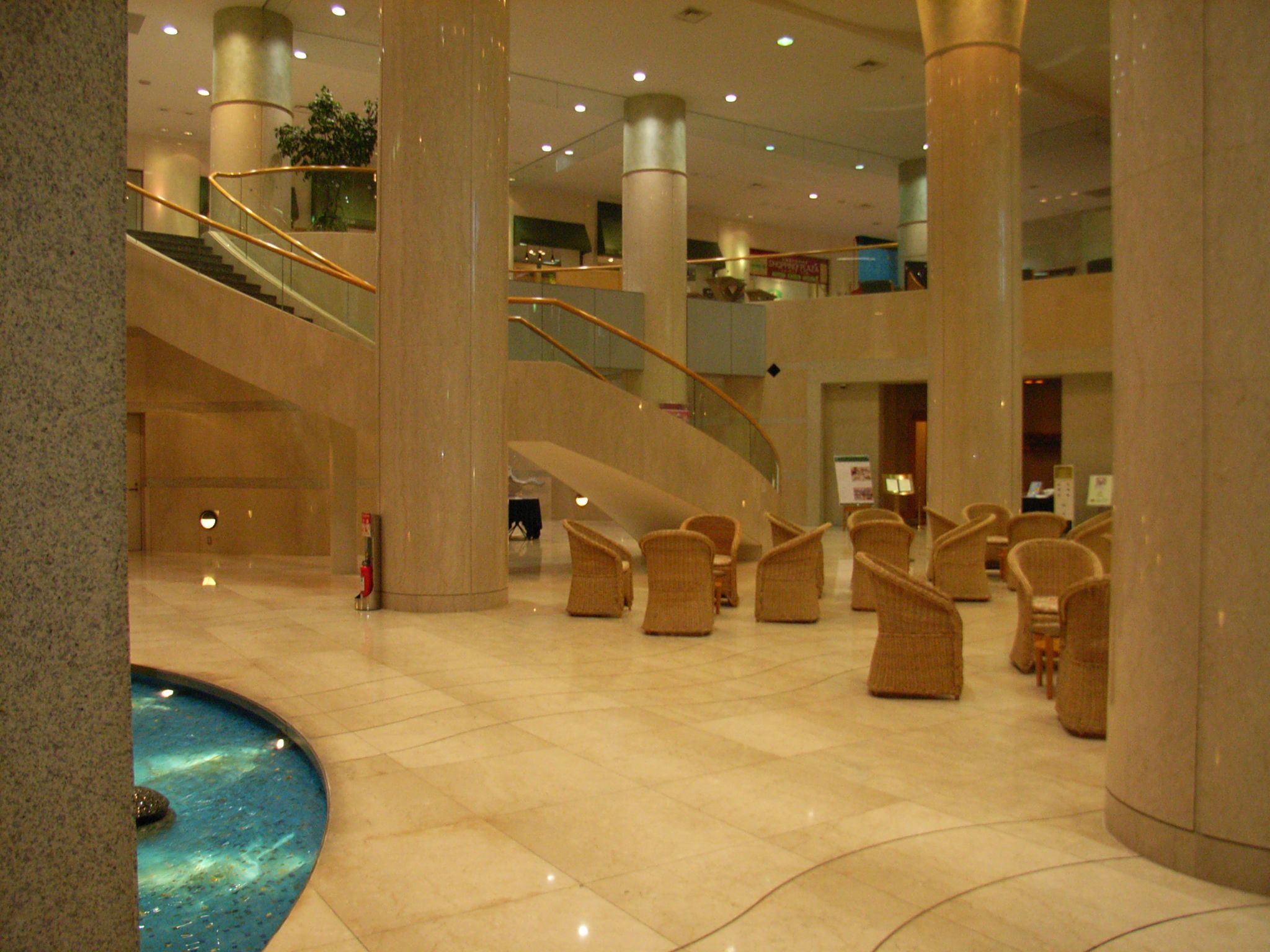 the large lobby has two spiral staircases and two sets of seating
