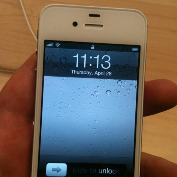 a hand holds an iphone displaying an event
