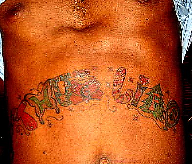 a man is showing off his tattoes with a knife