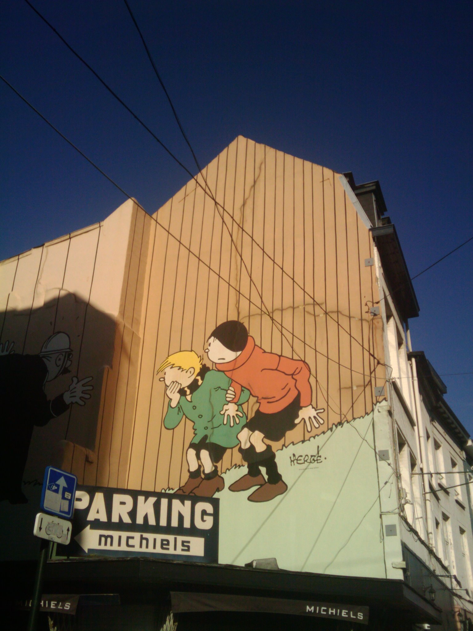 a building with a giant cartoon depicting two s and a dog