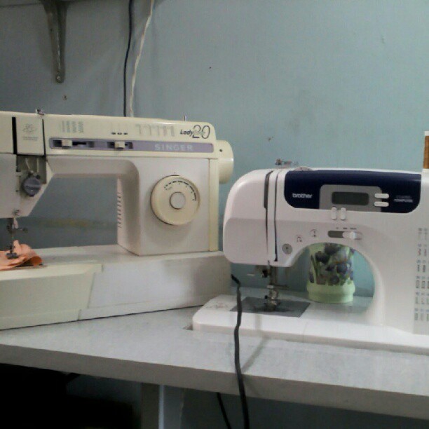 a sewing machine on a table next to an appliance