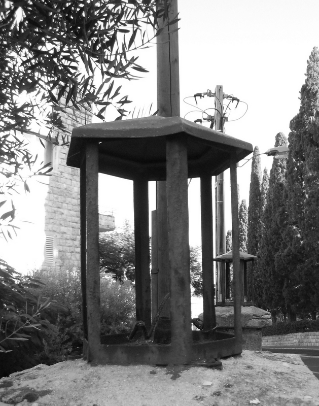 a stone cross is placed on top of an old wooden structure