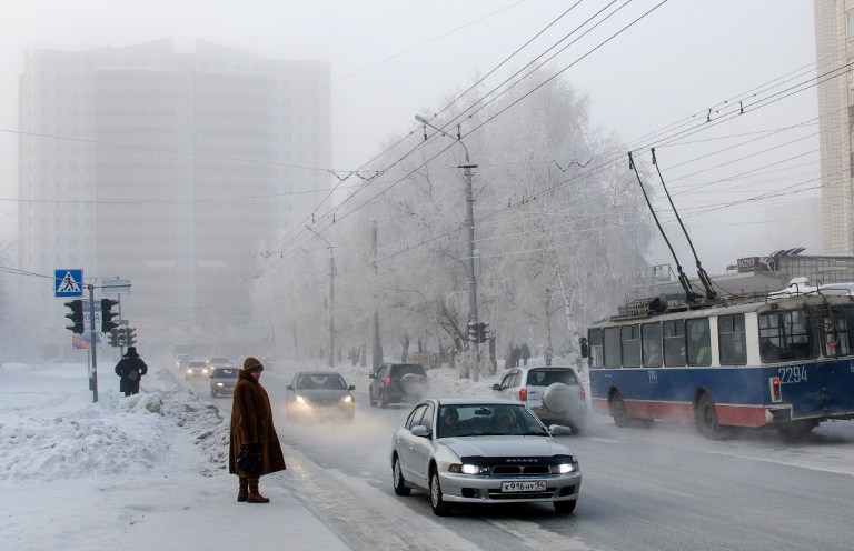 a car is parked near a street filled with snow