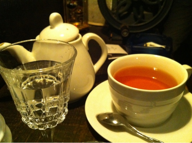a tea pot, glass of water and plate