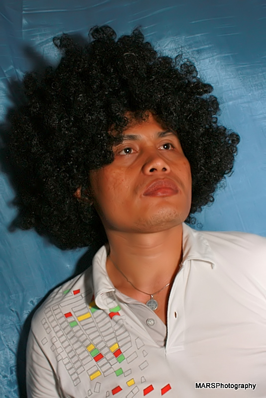 a man with a black afro and white shirt