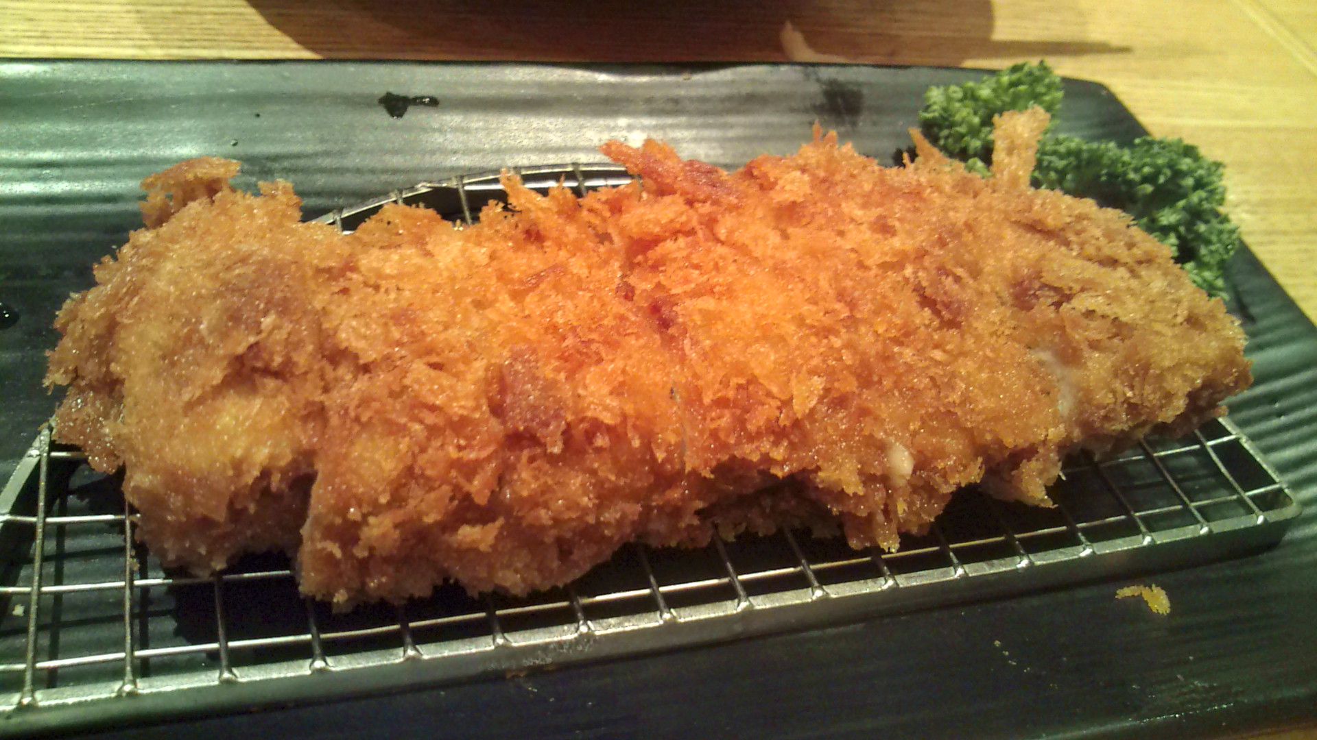 close up of fried meat on a metal rack
