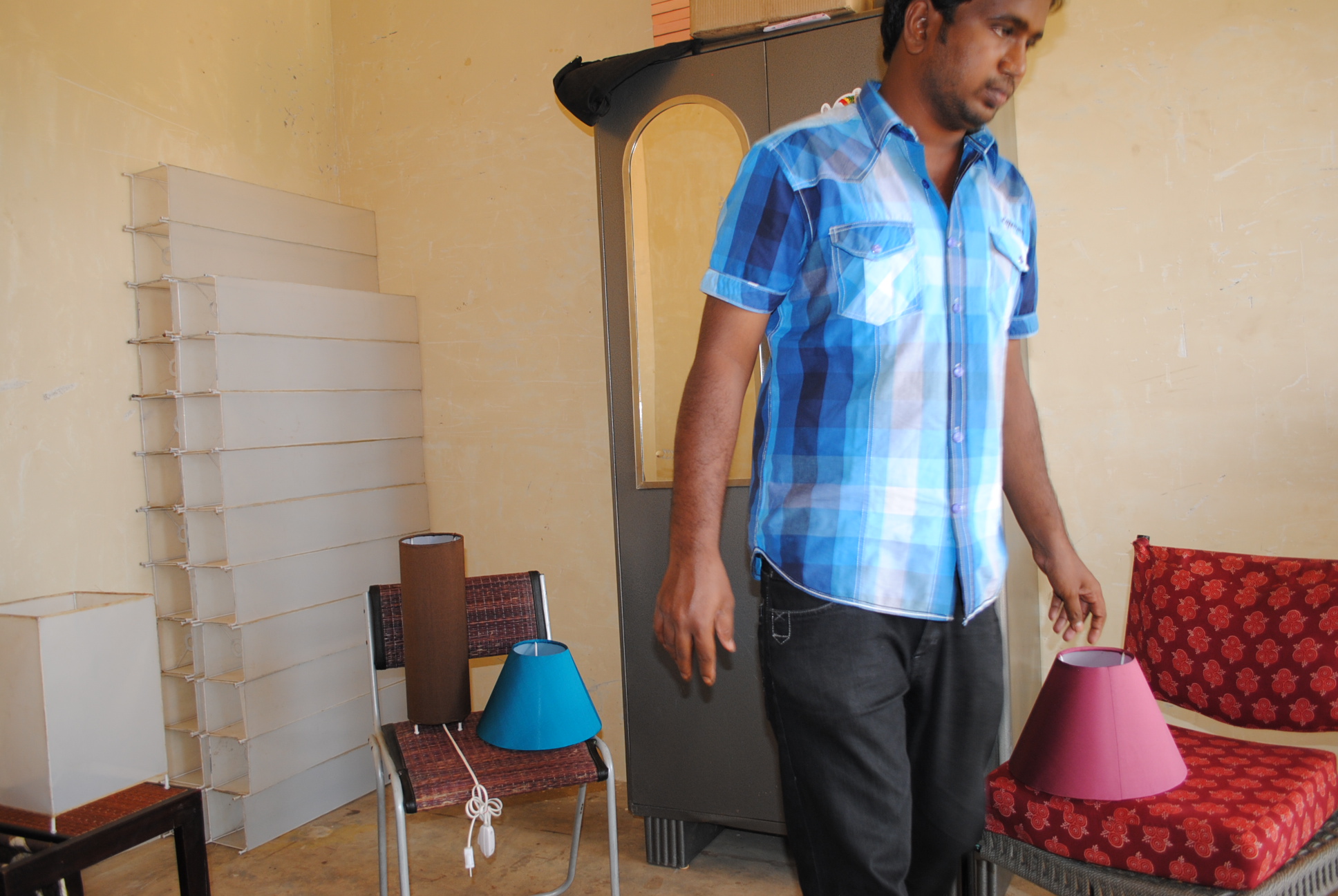 a man is standing by the door with some hats on it