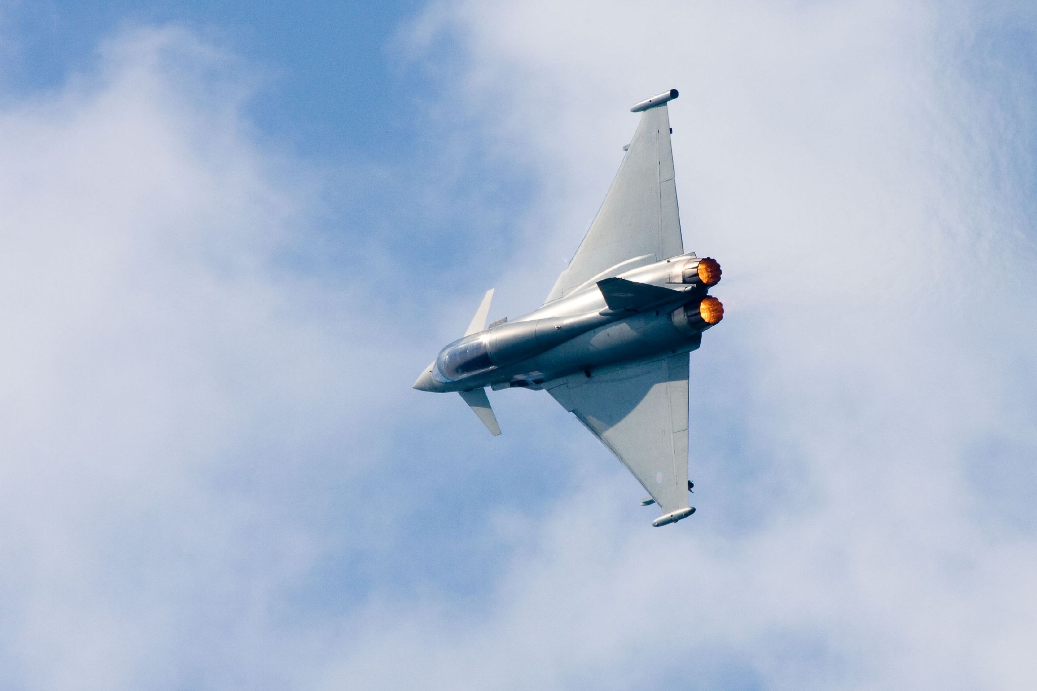 the jet is flying through the air under a cloudless sky