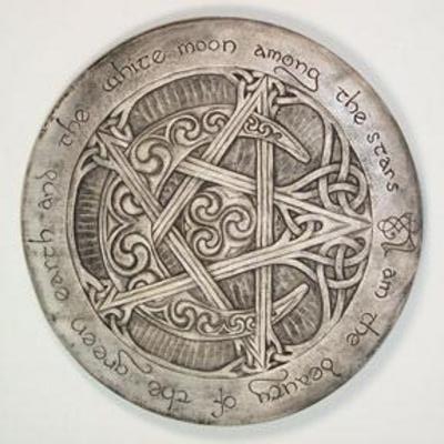 a metal disk with a pentagram and star