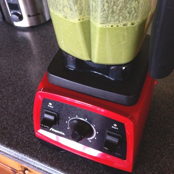 a blender with a red base on a counter top