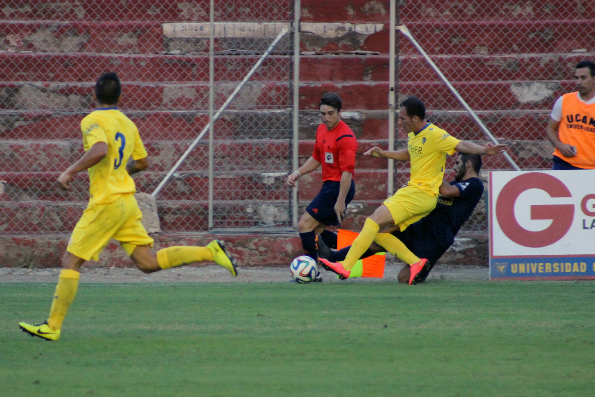 men playing soccer in front of a group of others