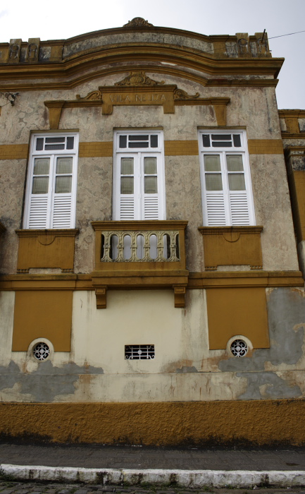 an old yellow building with white windows