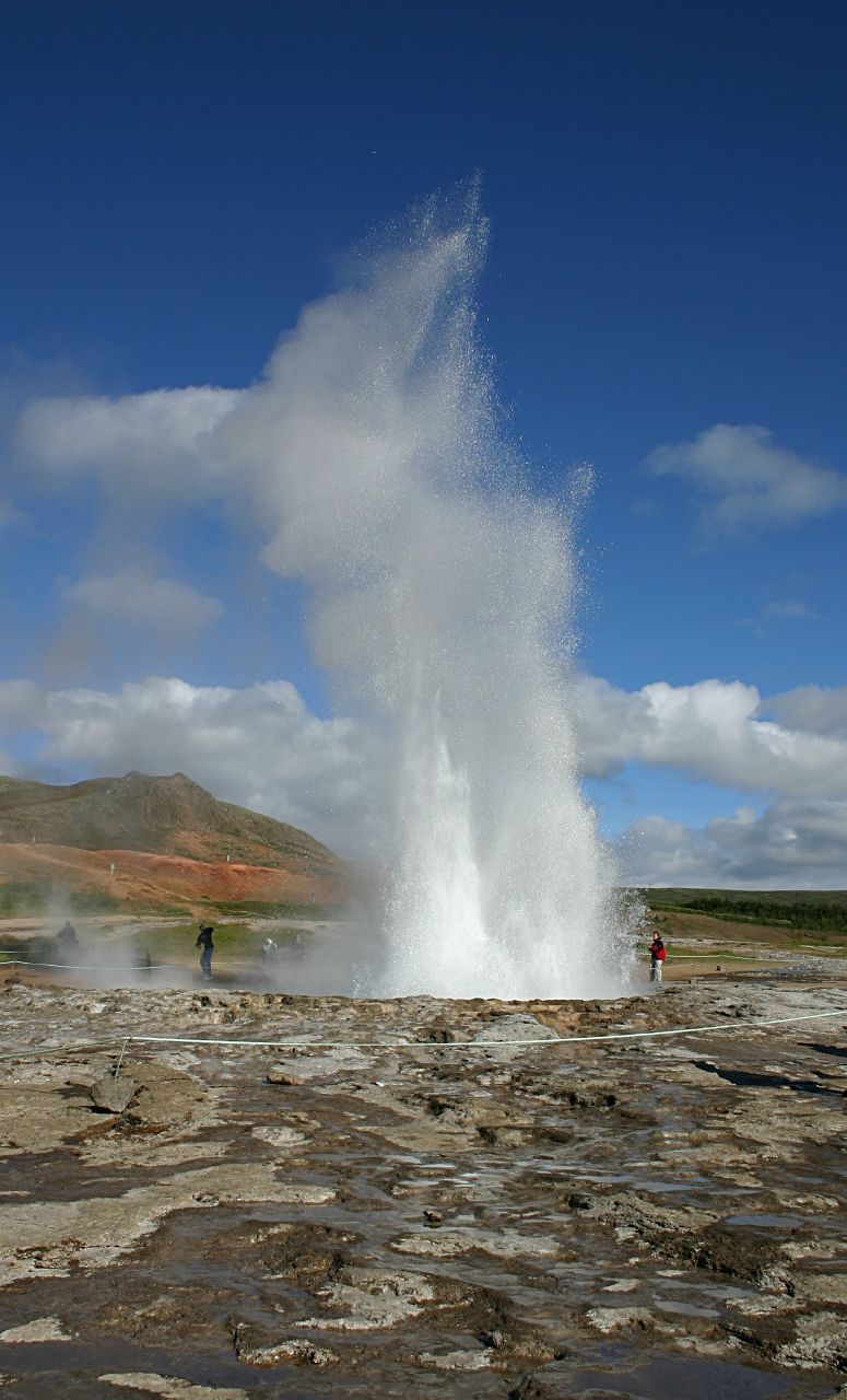 two people walking towards the big geyser