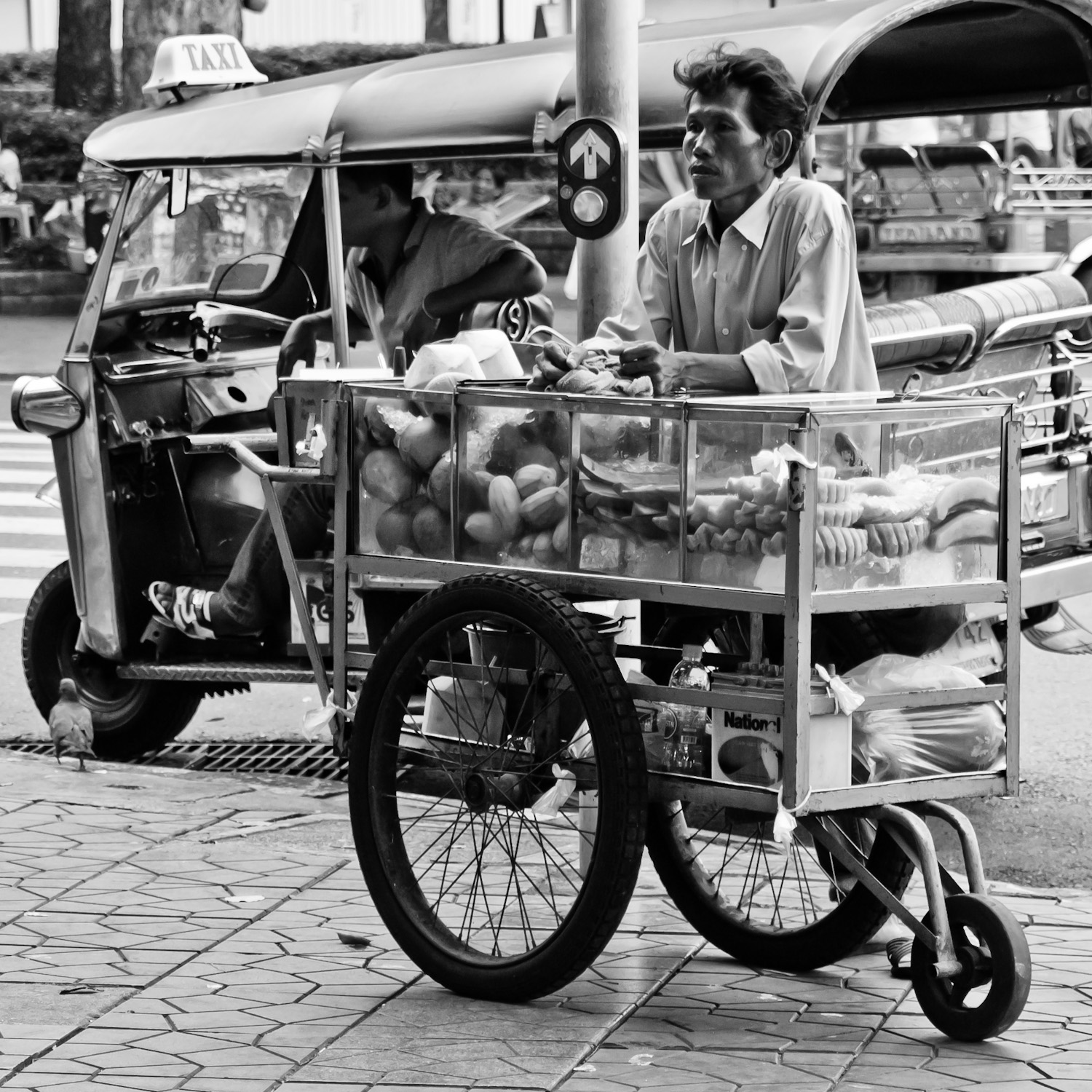 a black and white image of a street vendor