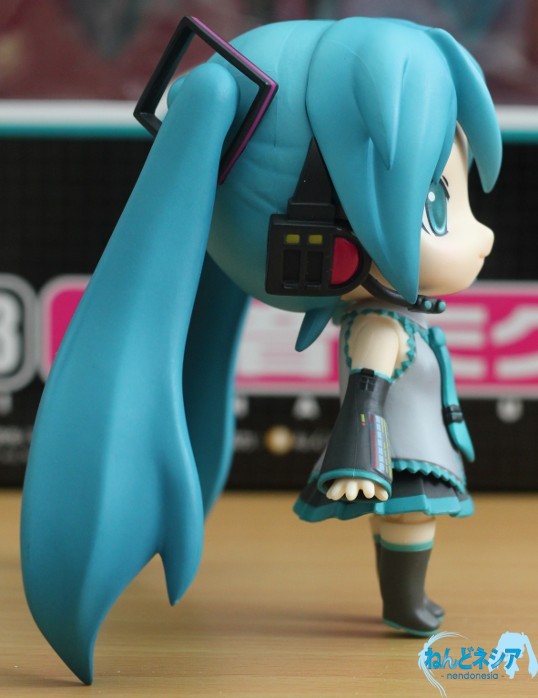 a little anime figurine, wearing a blue outfit and a big blue hat